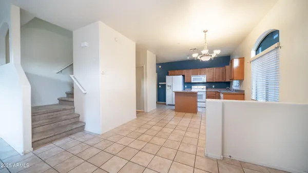 a view of a kitchen with furniture and an empty room