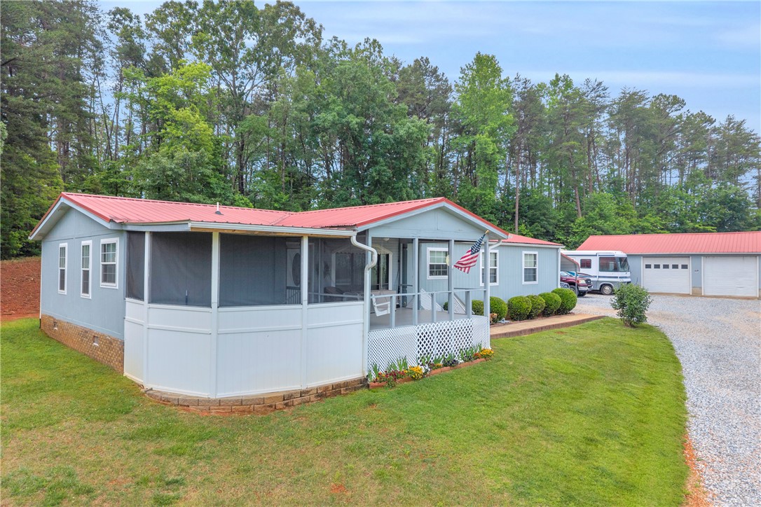 721 Cedar Crest Trail Walhalla, SC 29691 - Photo 1 of 47 A charming residence with a screened porch and detached garage, nestled among mature trees.