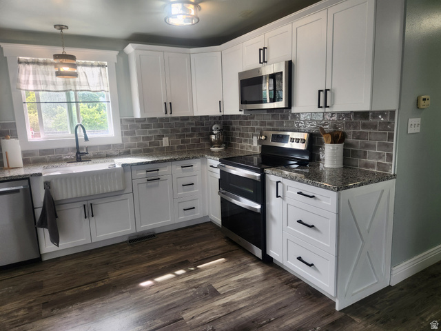 705 North 700 East Payson, UT 84651 - Photo 3 of 30 Kitchen with stainless steel appliances, dark stone countertops, and white cabinetry