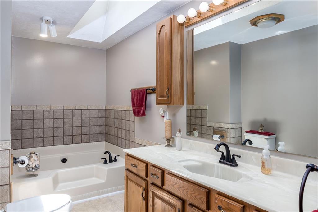 224 Vance Station Road Washington, PA 15301 - Photo 16 of 38 Hallway bathroom features skylight, garden tub and ceramic tile.