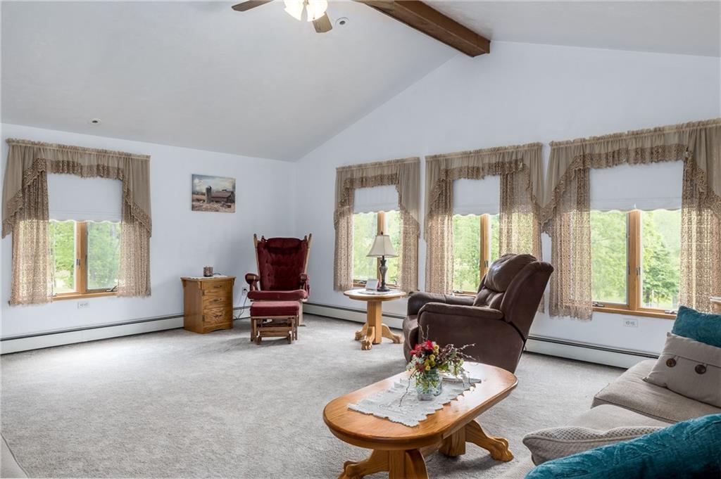 Wow!  Tons of natural light, exposed wood beam and cathedral ceiling.