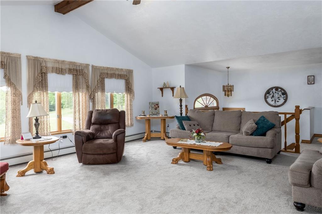 Living room with view to stairs to lower level.  New wall to wall carpet.