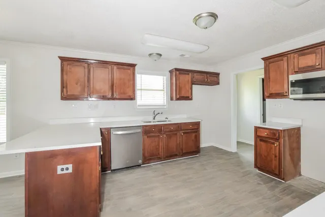 a kitchen with stainless steel appliances granite countertop a sink stove and microwave