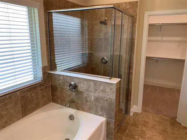 a bathroom with a tub and shower