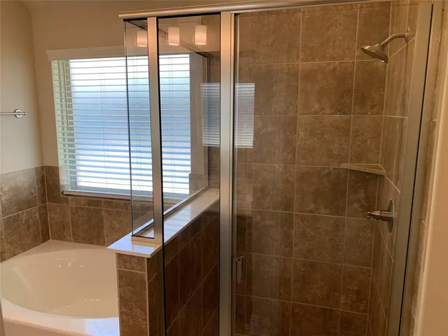 a bathroom with a bathtub and window