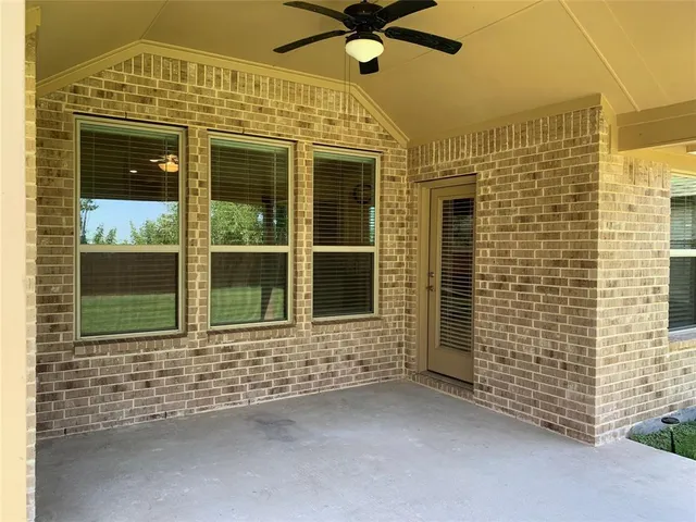 a view of a brick house with a large window