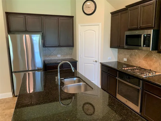 a kitchen with a stove and a refrigerator