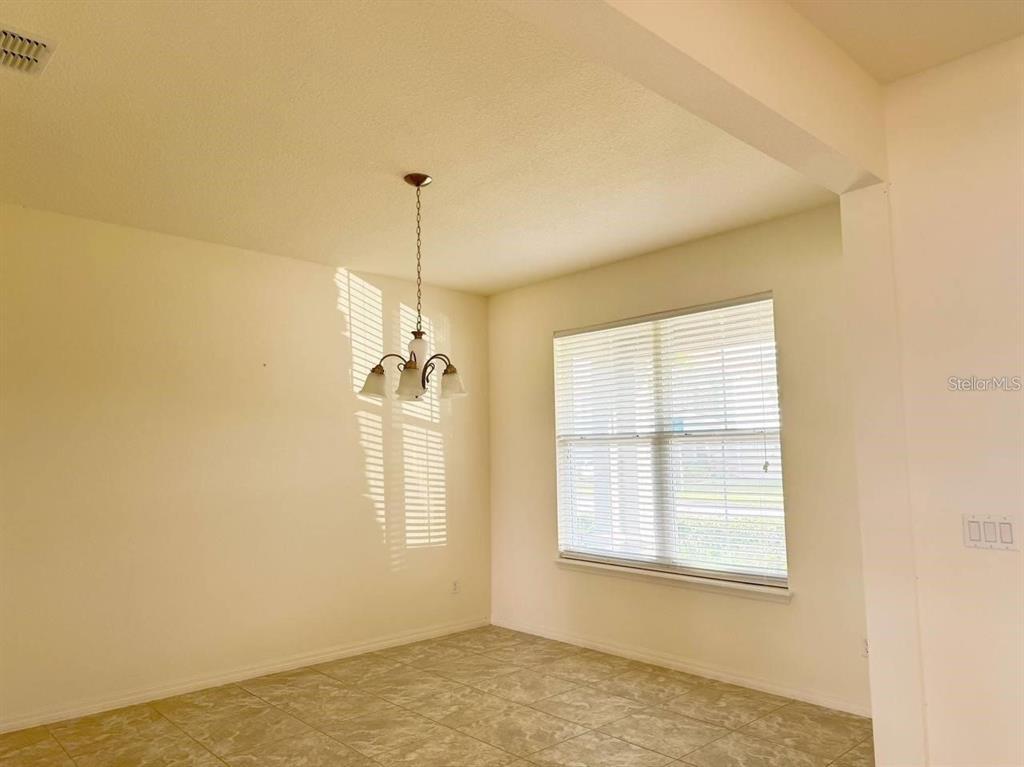 3877 Mount Vernon Way Kissimmee, FL 34741 - Photo 11 of 27 a view of an empty room with a window