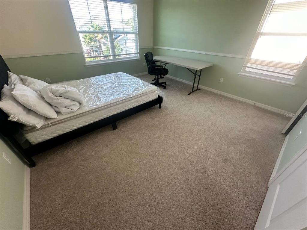 3877 Mount Vernon Way Kissimmee, FL 34741 - Photo 14 of 27 a bedroom with a bed and a window