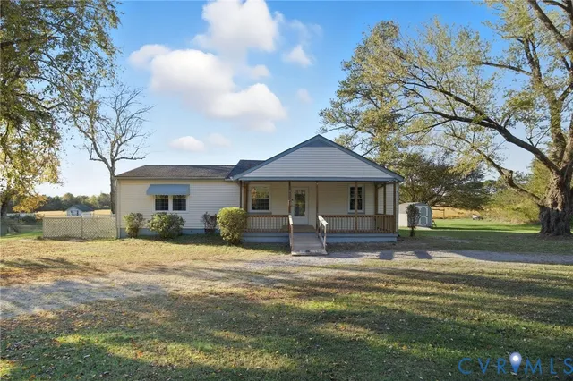 a house view with a sitting space and garden