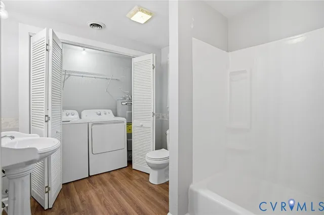 a bathroom with a sink toilet vanity and tub