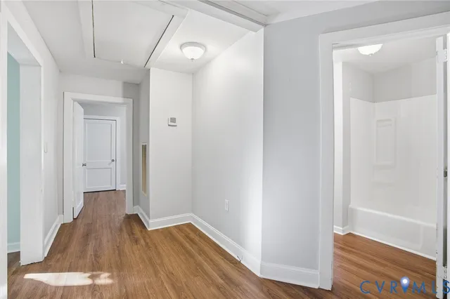 a view of a hallway with wooden floor