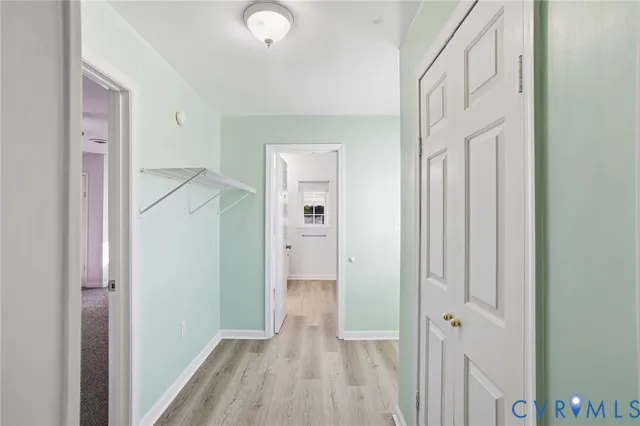 a view of a hallway with wooden floor