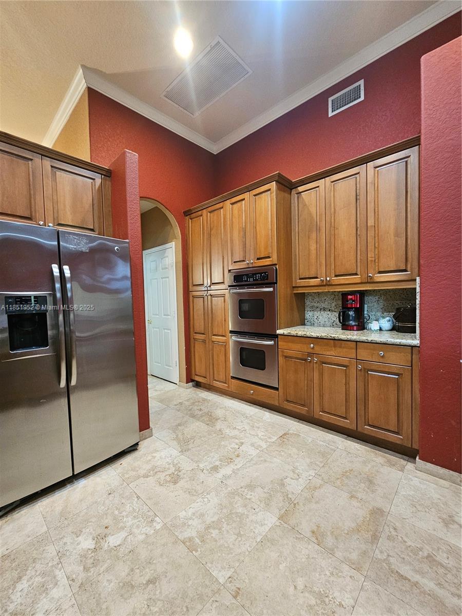 18951 Southwest 30th Street Miramar, FL 33029 - Photo 30 of 62 a kitchen with stainless steel appliances a refrigerator and a stove