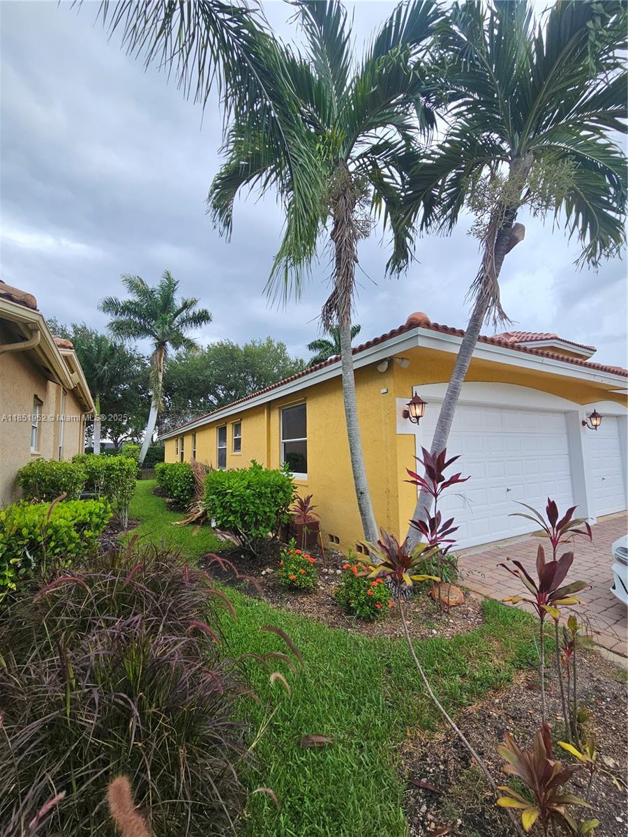 18951 Southwest 30th Street Miramar, FL 33029 - Photo 3 of 62 a view of a backyard house and swimming pool