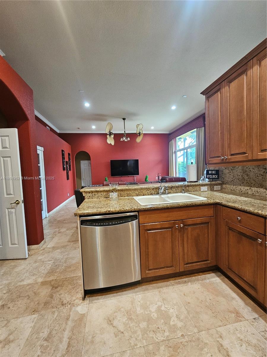 18951 Southwest 30th Street Miramar, FL 33029 - Photo 31 of 62 a kitchen with stainless steel appliances granite countertop a stove a sink and a refrigerator