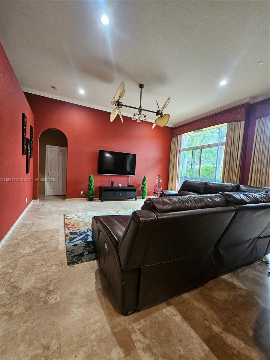 18951 Southwest 30th Street Miramar, FL 33029 - Photo 33 of 62 a living room with furniture a flat screen tv and a fireplace