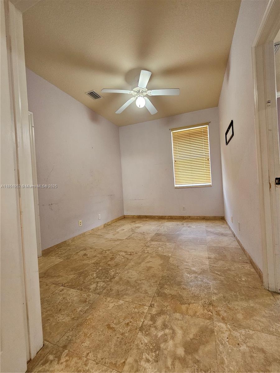 18951 Southwest 30th Street Miramar, FL 33029 - Photo 37 of 62 en empty room with ceiling fan and window