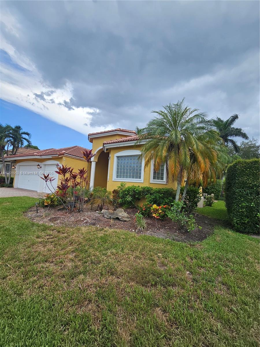 18951 Southwest 30th Street Miramar, FL 33029 - Photo 4 of 62 a front view of house with yard and green space