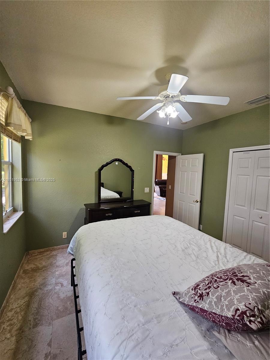 18951 Southwest 30th Street Miramar, FL 33029 - Photo 44 of 62 a bedroom with a bed and a chandelier