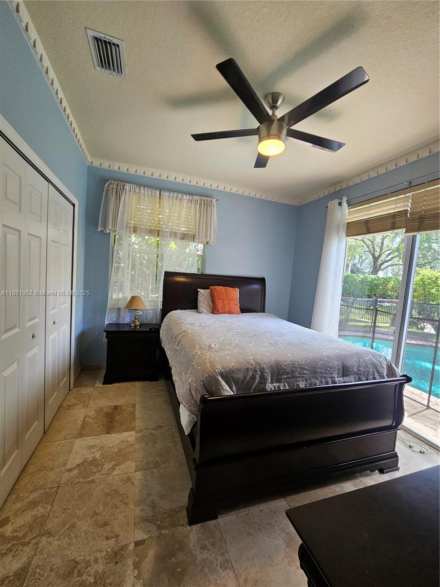 18951 Southwest 30th Street Miramar, FL 33029 - Photo 46 of 62 a bedroom with a large bed and a large window