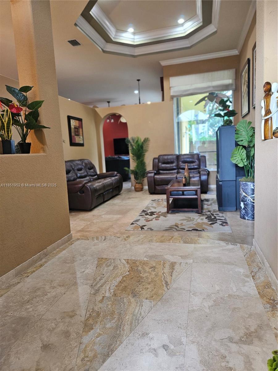 18951 Southwest 30th Street Miramar, FL 33029 - Photo 7 of 62 a living room with furniture and a flat screen tv