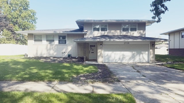 2958 191st Street Lansing, IL 60438 - Photo 1 of 25 a front view of a house with a garden