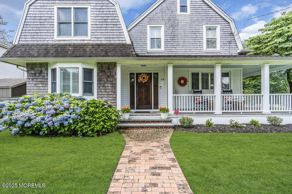 24 Chestnut Street Fair Haven, NJ 07704 - Photo 2 of 42 a front view of a house with a garden and plants