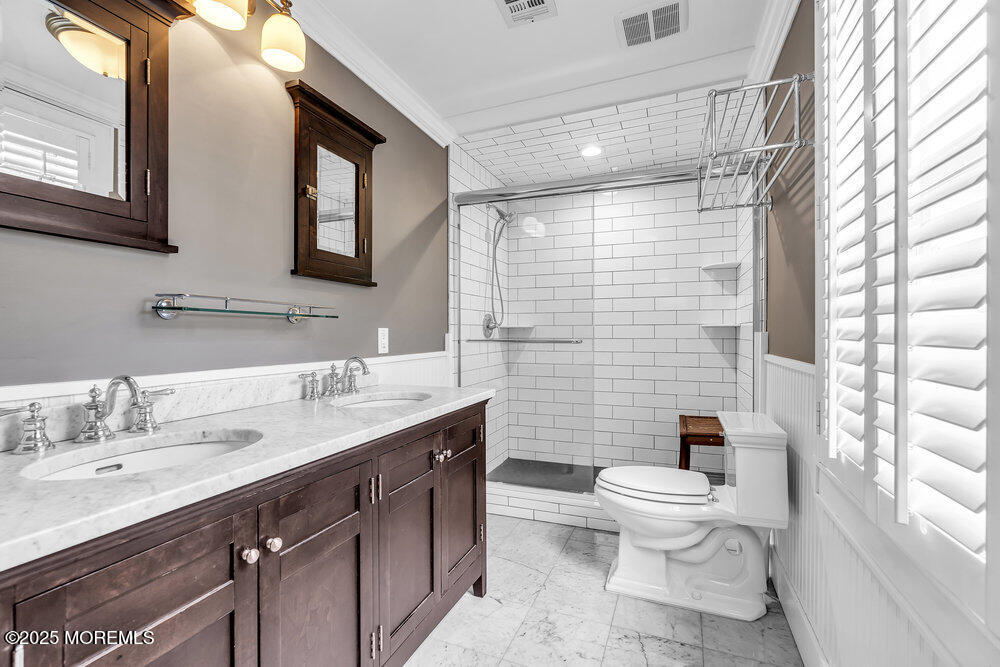 24 Chestnut Street Fair Haven, NJ 07704 - Photo 29 of 42 a bathroom with a double vanity sink toilet and shower