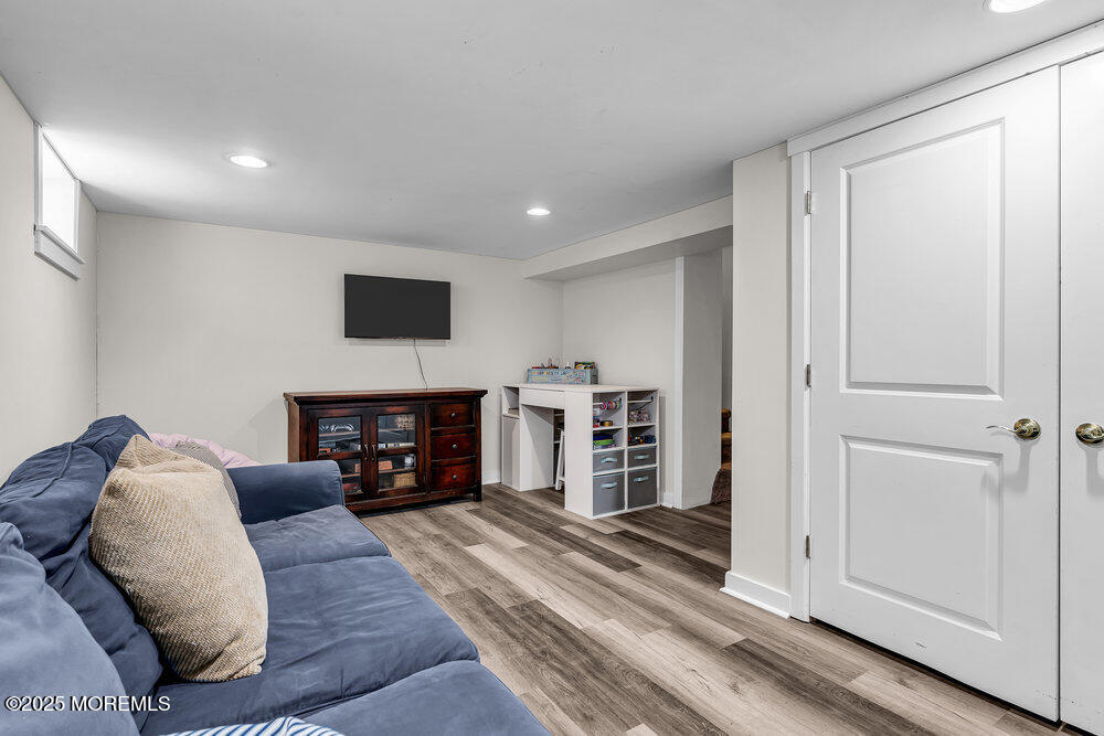 24 Chestnut Street Fair Haven, NJ 07704 - Photo 33 of 42 a living room with furniture a fireplace and a flat screen tv