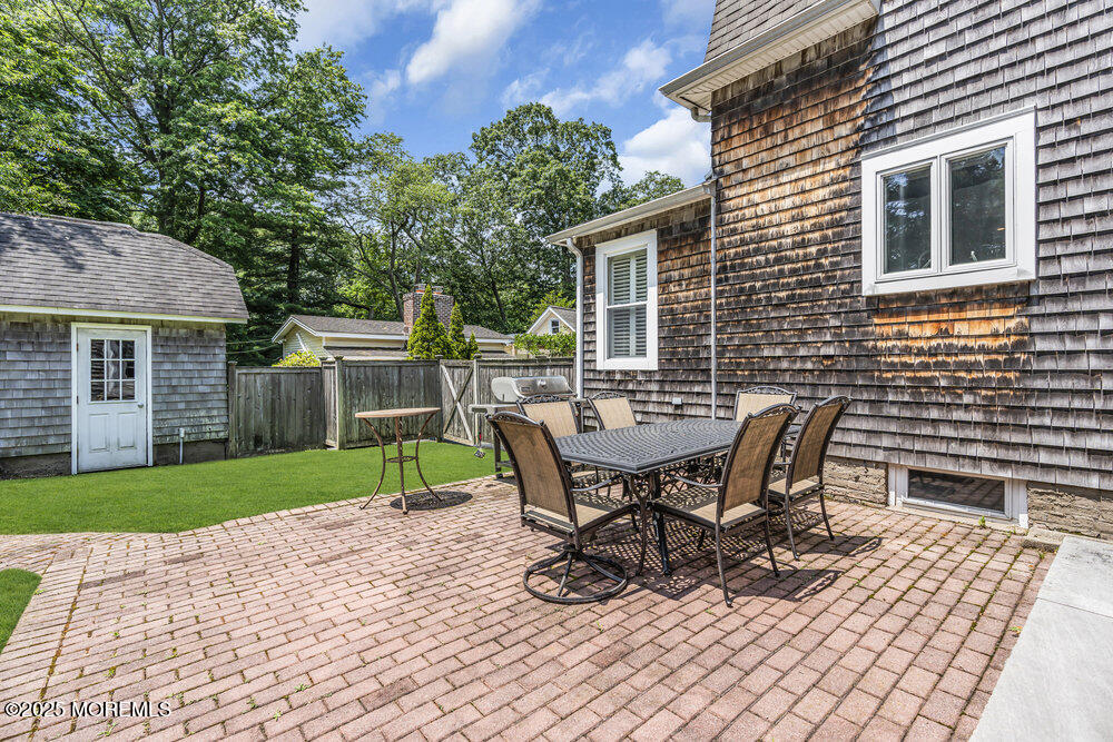 24 Chestnut Street Fair Haven, NJ 07704 - Photo 35 of 42 a view of a patio with table and chairs and floor to ceiling window