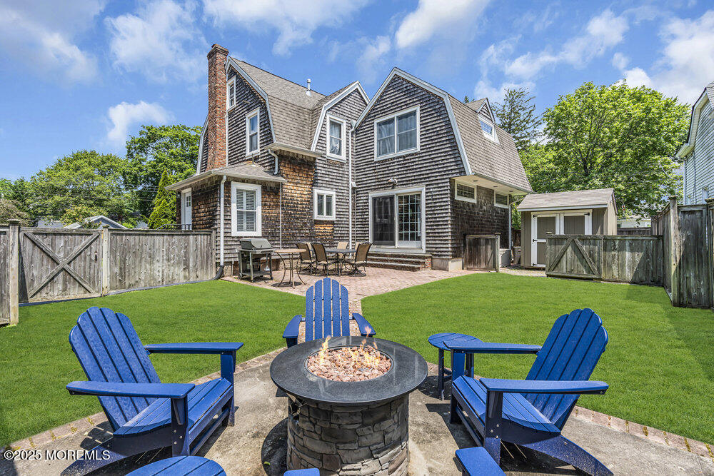24 Chestnut Street Fair Haven, NJ 07704 - Photo 38 of 42 a view of a chairs and table in backyard of the house