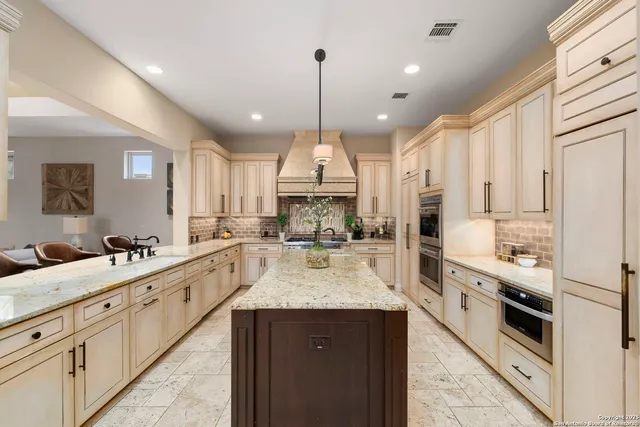 a kitchen with center island table and a sink