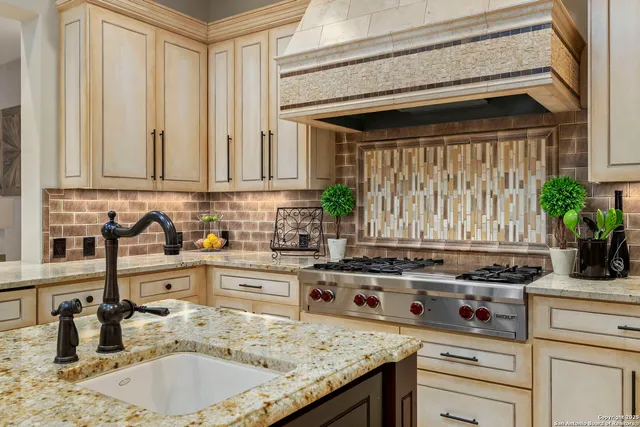 a living room with furniture a fireplace and a chandelier