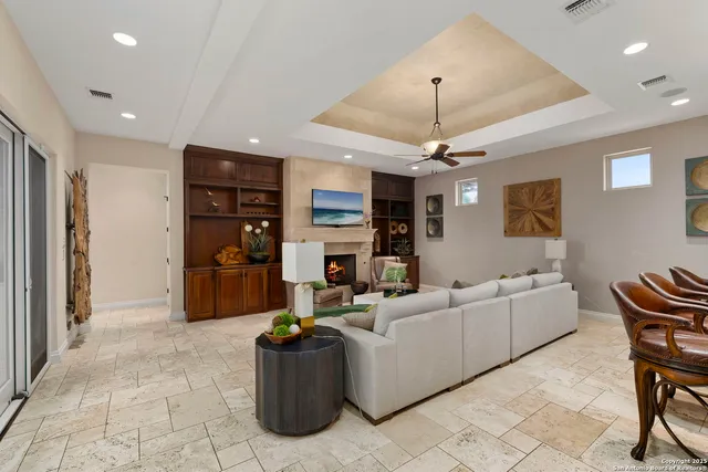 a living room with furniture and a chandelier