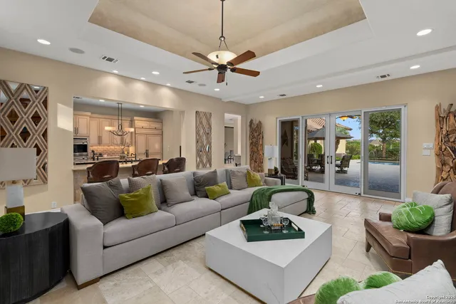 a living room with furniture a fireplace and a large window