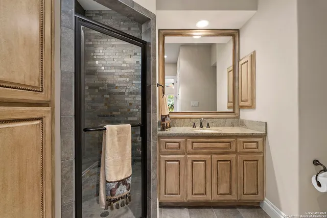 a living room with furniture a flat screen tv and a book shelf