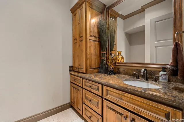 a bathroom with a sink mirror and toilet