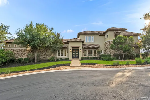 a front view of house with yard and green space