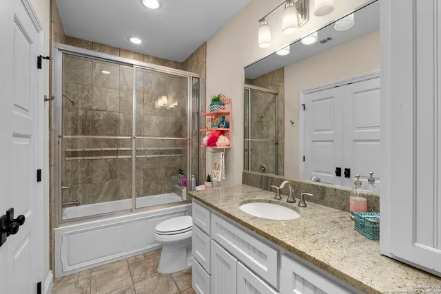 a kitchen with granite countertop a stove and a refrigerator