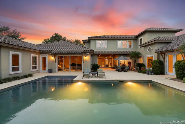 a swimming pool with outdoor seating and yard