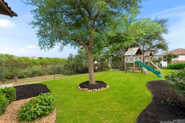 a view of a house with a yard and lake view