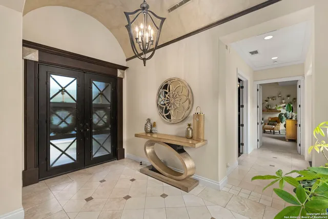 a view of a dining room with furniture a chandelier and wooden floor