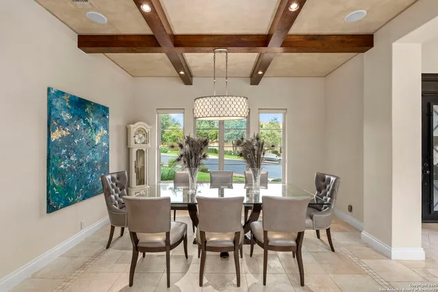 a kitchen with kitchen island a table and chairs in it