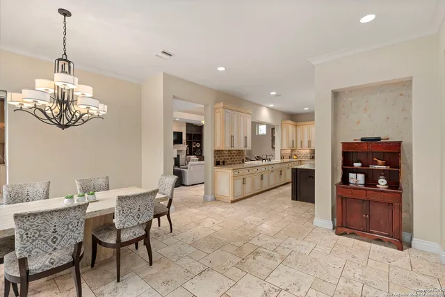 a large kitchen with granite countertop a stove top oven a sink a counter space and cabinets