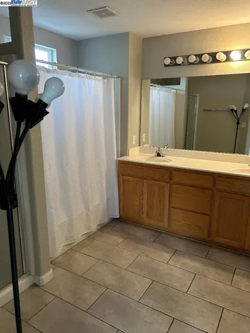 a bathroom with a sink a mirror and a shower