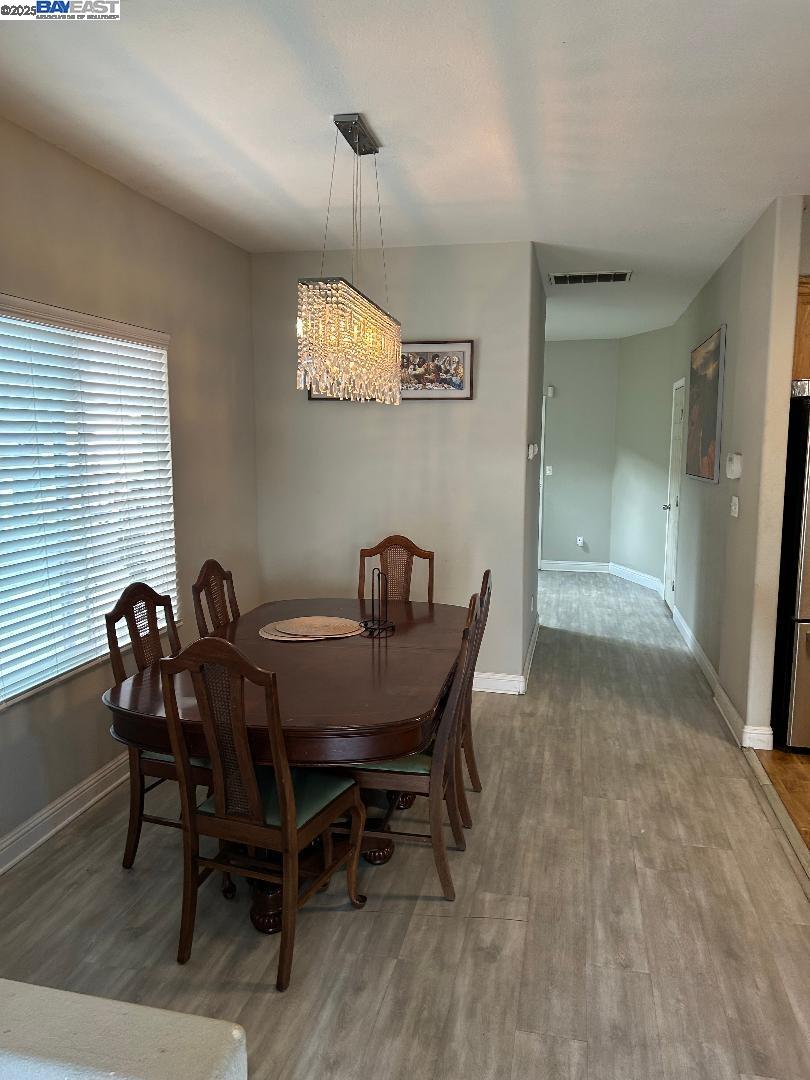 112 Gibson Avenue Bay Point, CA 94565 - Photo 4 of 19 a view of a dining room with furniture and chandelier