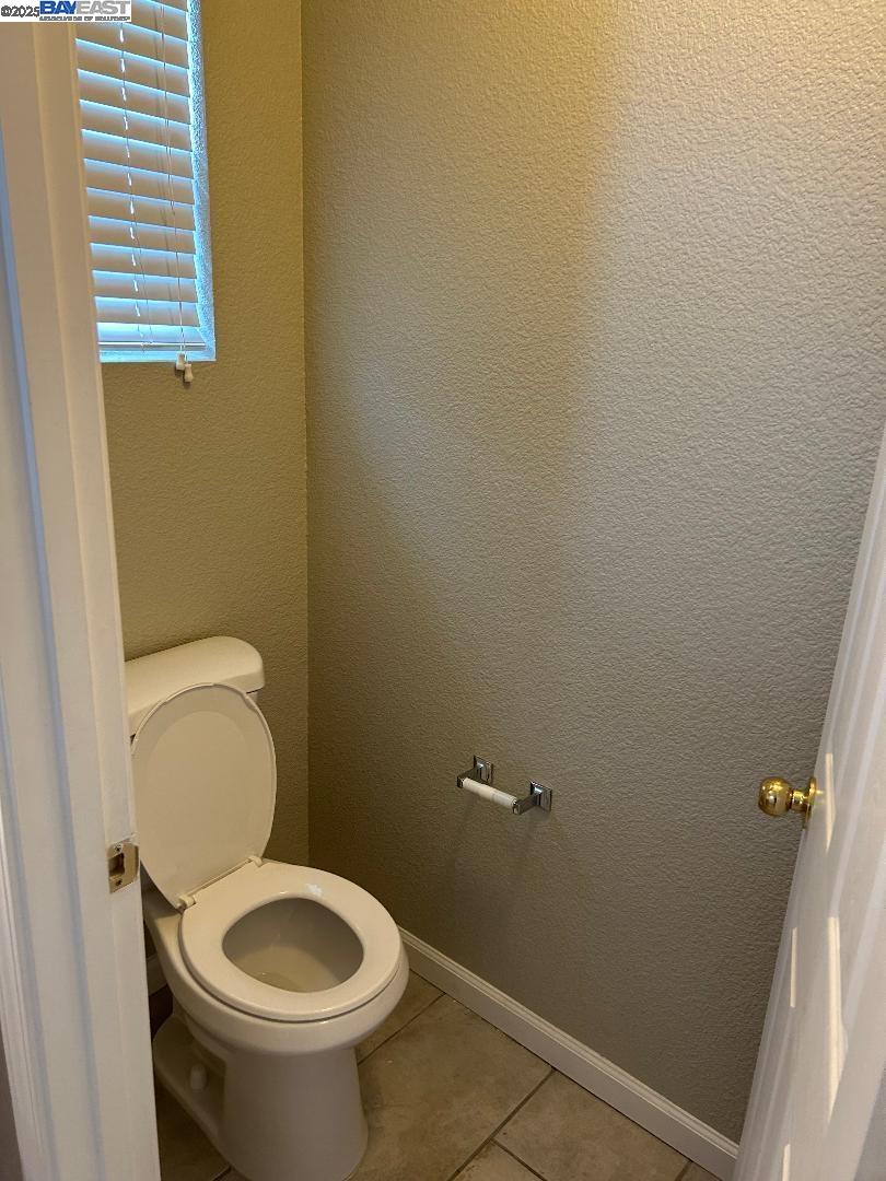 112 Gibson Avenue Bay Point, CA 94565 - Photo 10 of 19 a white toilet sitting in a bathroom next to a sink