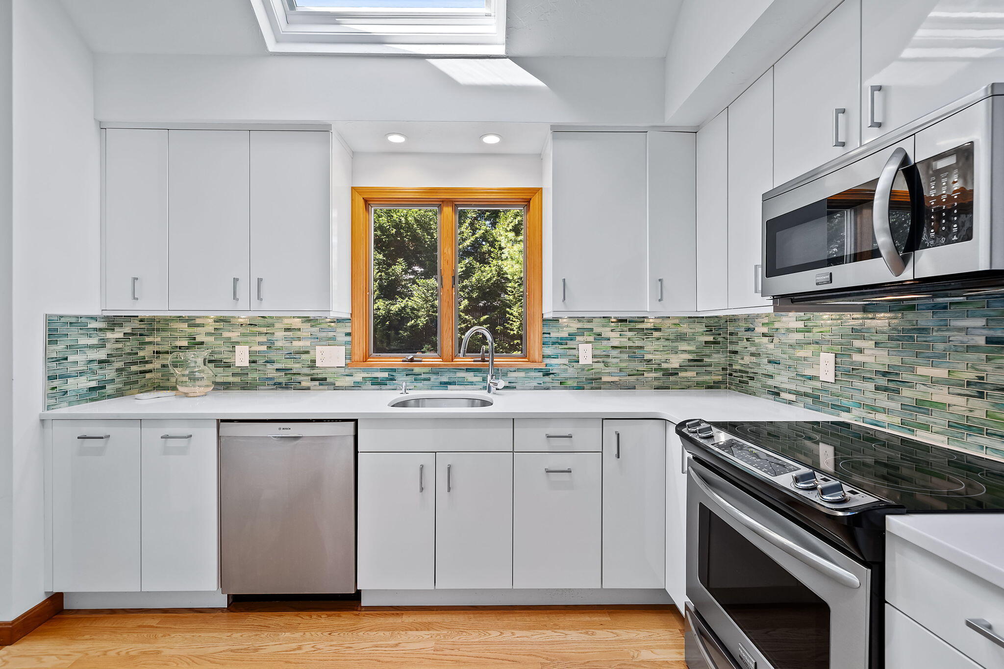 12 Crowell Road Harwich Port, MA 02646 - Photo 7 of 28 a kitchen with stainless steel appliances granite countertop a stove and a microwave