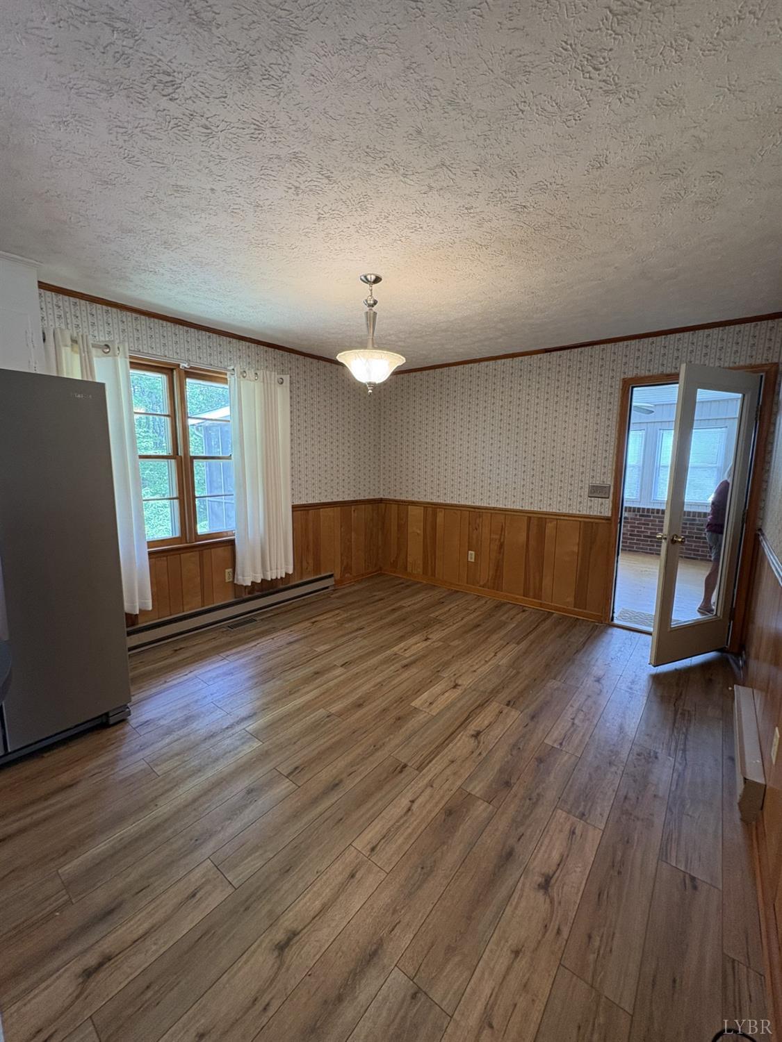 1796 Owens Mill Road Gretna, VA 24557 - Photo 6 of 20 an empty room with wooden floor and windows